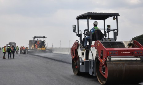 Sejumlah pekerja PT Hutama Karya melakukan pengaspalan jalan tol Medan-Binjai di seksi I B Helvetia-Tanjung Mulia di Medan, Sumatera Utara, Sabtu (30/3/2019). 