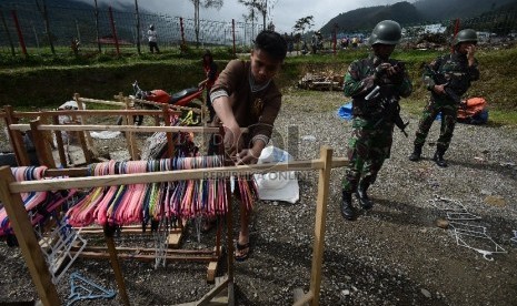 Sejumlah pengungsi korban kebakaran kios menyiapkan barangnya untuk kemudian dipindahkan ke Kantor Bupati Tolikara, Papua, Jumat (24/7). (Republika/Raisan Al Farisi)