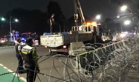 Sejumlah petugas sedang memasang separator beton di Jalan Imam Bonjol, depan kantor KPU, Selasa (21/5) dinihari.