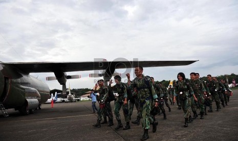   Sejumlah prajurit Korpaskhas TNI Angkatan Udara menuju pesawat Hercules untuk melakukan aksi penerjunan saat acara peringatan HUT TNI AU ke-67 di Lanud Halim Perdanakusumah, Jakarta Timur, Selasa (9/4).  (Republika/Edwin Dwi Putranto)