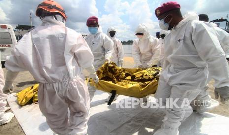 Sejumlah prajurit TNI AL membawa satu kantung jenazah awak kapal yang berhasil ditemukan KRI Kerambit di dermaga Pelabuhan Dwikora, Pontianak, Kalimantan Barat, Selasa (20/07/2021). KRI Kerambit-627 mengevakuasi dua awak Kapal Motor Kawan Lama asal Kalbar bernama Aris (27) dan Maulana (20) yang selamat, serta lima jenazah awak kapal yang ditemukan di 130 mil sebelah barat laut Pemangkat, Kabupaten Sambas saat melaksanakan operasi pencarian korban kapal tenggelam di Perairan Kalbar. 