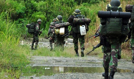 Sejumlah prajurit TNI menyusuri jalan setapak dalam hutan untuk memburu kelompok Santoso di Desa Sedoa, Lore Utara, Poso, Sulawesi Tengah, Kamis (24/3). 