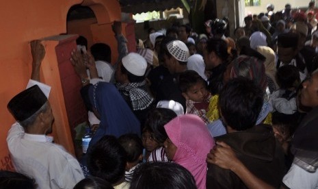 Sejumlah warga berebut masuk ke Makam Loang Baloq di Mataram, NTB, Rabu (7/9). Makam Loang Baloq merupakan salah satu lokasi yang ramai dikunjungi warga untuk berziarah saat merayakan Lebaran.