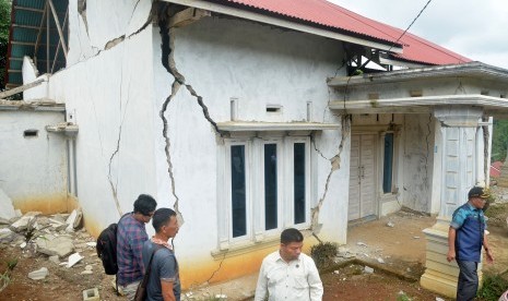 Gempa Solok: Sejumlah warga memperhatikan rumah yang rusak akibat gempa di Kabupaten Solok Selatan, Sumatera Barat, Kamis (28/2/2019). 