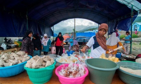 Sejumlah warga menyiapkan makanan di dapur umum Kamp Pengungsi Kelurahan Duyu, Palu, Sulawesi Tengah, Jumat (30/11/2018). 