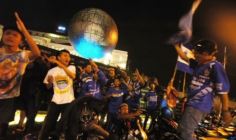 Sejumlah warga merayakan kemenangan Persib di Jalan Asia Afrika, Kota Bandung, Ahad (18/10) malam. (foto : Septianjar Muharam)