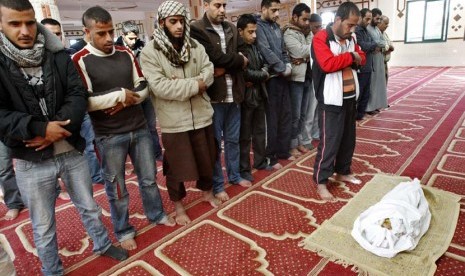  Sejumlah warga Palestina menyalatkan jenazah Iyad, anak balita yang berusia satu setengah tahun di sebuah masjid di Kamp Pengungsi Bureij,Gaza, Ahada (18/11). (AP Photo/Adel Hana)