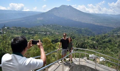 A foreign tourist enjoys the view of Geopark Batur in Kintamani, Bangli, Bali.