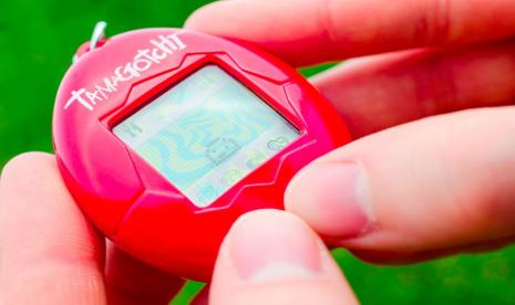 Seorang anak memainkan Tamagotchi,