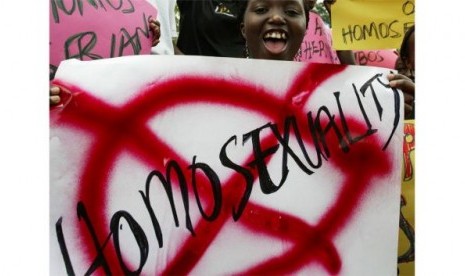 Seorang demonstran di Uganda menunjukkan poster anti-homoseksual.