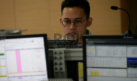 Seorang karyawan mengamati pergerakan saham di Mandiri Sekuritas, Jakarta, Selasa (3/2).(Republika/Prayogi)