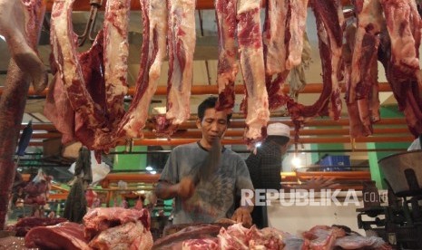  Seorang pedagang daging sedang memotong rusuk-rusuk sapi di pasar Jatinegara Jakarta, Ahad (30/4). 