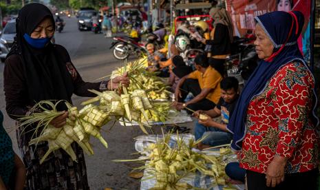 Seorang pembeli memilih bungkus ketupat yang dijual pedagang musiman ketupat di pasar krempyeng atau pasar tumpah pinggir jalan di Penggaron, Semarang, Jawa Tengah, Ahad (1/5/2022). Menjelang Hari Raya Idul Fitri 1443 Hijriah, sejumlah pasar tradisional maupun pasar tumpah pinggir jalan di Kota Semarang dipadati pedagang musiman yang berjualan bungkus ketupat seharga Rp10 ribu - Rp15 ribu per ikat (isi 10) tergantung ukuran.