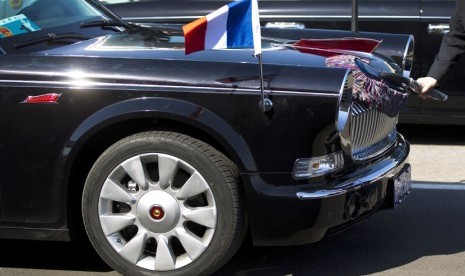  Seorang pengemudi mengelap mobil limusin mewah buatan Cina Hongqi, yang akan digunakan untuk menyambut kunjungan Presiden Perancis di Bandara Internasional Beijing,Cina, Kamis (25/4).   (AP/Andy Wong)