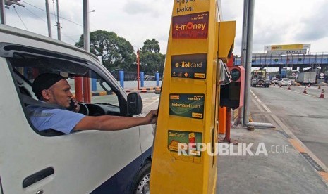 Seorang pengemudi mobil pengguna jalan tol bertransaksi menggunakan kartu elektronik non tunai ketika akan keluar dari tol Belmera Amplas Medan, Sumatera Utara, Rabu (13/9). Mulai 17 September 2017, PT Jasa Marga akan memberlakukan pembayaran di gerbang tol Belmera seluruhnya secara non tunai dengan menggunakan uang elektronik yang dianggap lebih praktis dan aman.