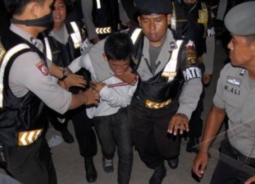 Seorang perusuh diamankan polisi saat terjadi kerusuhan di pintu masuk lokasi pembukaan SEA Games XXVI di kompleks Stadion Olahraga Sriwijaya, Jaka Baring, Palembang Sumsel, Jumat (11/11).