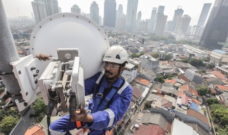 Seorang teknisi XL Axiata sedang melakukan pemeliharaan perangkat BTS (Base Transceiver Station) di sebuah tower yang berada di bilangan Bendungan Hilir, Jakarta Selatan, Jumat (13/7). 