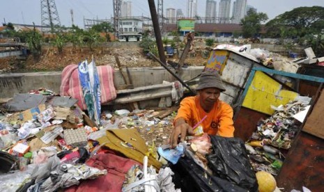 Seorang tukang sampah mengumpulkan sampah. Penghasilan yang diterima jauh dari kata layak untuk hidup di Jakarta, Rp 800 ribu per bulan.