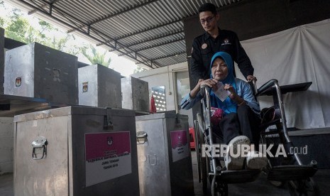 Seorang warga difabel mendapat bantuan saat memasukkan surat suara ke dalam kotak suara, saat simulasi pencoblosan Pilkada Serentak 2018, di Purwokerto, Banyumas, Jawa Tengah, Kamis (3/5).