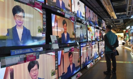 Seorang warga menonton pidato Pemimpin Eksekutif Hong Kong Carrie Lam mengenai ditariknya RUU Ekstradisi di sebuah toko elektronik di Hong Kong, Rabu (4/9).