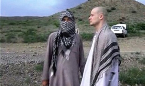 Sgt. Bowe Bergdahl (right) stands with a Taliban fighter in eastern Afghanistan.