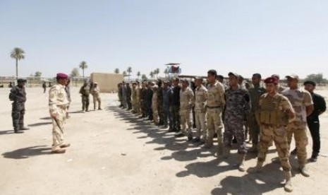 Shi'ite volunteers, who have joined the Iraqi army to fight against militants of the Islamic State, formerly known as the Islamic State of Iraq and the Syam (ISIS), stand during training in Baghdad, July 9, 2014. 