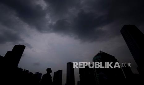 Siluet petugas keamanan berdiri saat awan mendung menghiasi langit Jakarta, Rabu (21/10). Kementerian Pertanian (Kementan) mengambil sejumlah kebijakan untuk mengantisipasi dan memitigasi dampak badai La Nina yang mulai menerjang sebagian wilayah Indonesia. Menteri Pertanian Syahrul Yasin Limpo menjelaskan, terdapat sejumlah strategi kebijakan yang sudah diambil untuk mitigasi La Nina. 