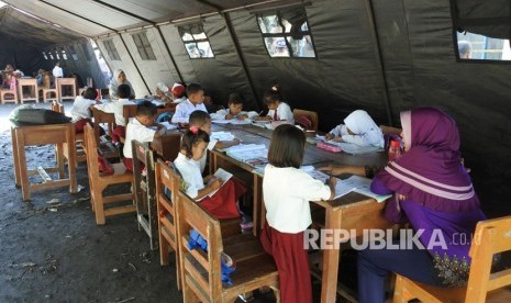 Siswa SDN Jamintoro 3 belajar di tenda di Desa Jamintoro, Sumberbaru, Jember, Jawa Timur, Senin (2/12/2019).