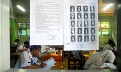 Siswa-siswi Sekolah Menengah Kejuruan (SMK) menyelesaikan Ujian Nasional bahasa Indonesia di SMK Negeri 8 jakarta, Senin (16/4). 