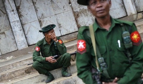 Soldiers pass their time as they guard the city in Lashio township May 30, 2013. 