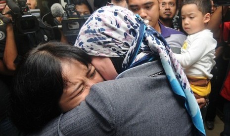 Some family members of Sukhoi passangers weep and anxiously wait the fate of their beloved ones who fly on board with Sukhoi Superjet 100in Halim Perdana Kusuma Airport, Jakarta.   