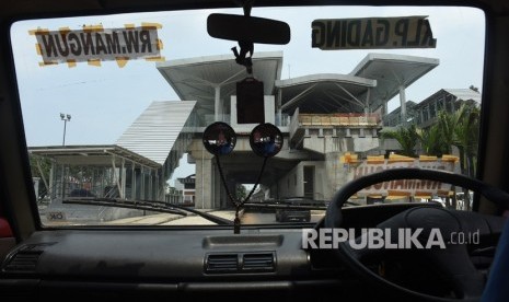 Sopir angkutan kota menunggu penumpang di dekat Stasiun LRT Velodrome yang dalam tahap penyelesaian pembangunan di Rawamangun, Jakarta, Sabtu (16/2/2019). 