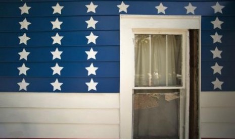 Stars and stripes are painted on the siding around a window of a 110-year-old house owned by Brent and Catherine Greer in Bradenton, Florida, June 6, 2014. 