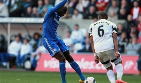 Striker Chelsea Demba Ba (kiri) melesakkan gol ke gawang Swansea City dalam lanjutan Liga Primer Inggris, Senin (14/4) dini hari.