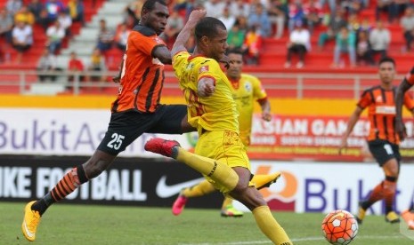 Striker Sriwijaya FC Hilton Moreira (kanan) menendang bola dijaga satu pemain Perseru Serui.