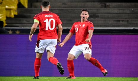 Striker Swiss Mario Gavranovic (kanan) meluapkan emosi setelah mencetak gol ketiga timnya pada laga kontra Jerman di Koln, Rabu (14/10).