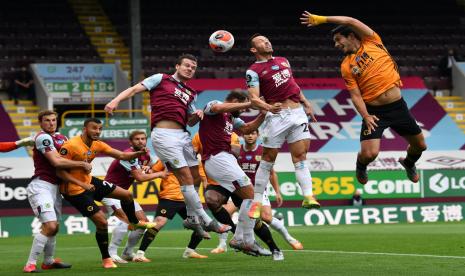 Striker Wolverhampton Wanderers (Wolves) Raul Jimenez (kanan) menanduk bola dalam laga melawan Burnley. Wolves ditahan imbang Burnley 1-1.