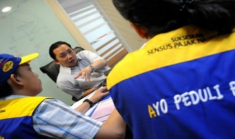 Tax officers (in blue uniform) are doing a census in an office area in Senayan City, Jakarta, recently.  The national census 2012 aims at listing new taxpayers to increase tax reciepts.     