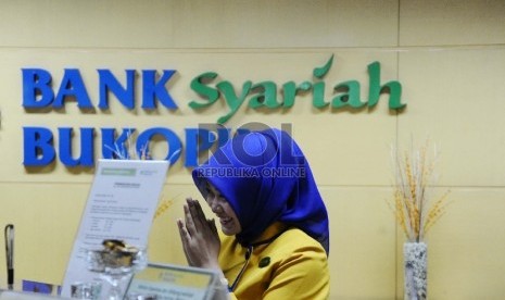 Teller melakukan aktifitas di kantor Bank Syariah Bukopin, Jakarta, Selasa (6/10).