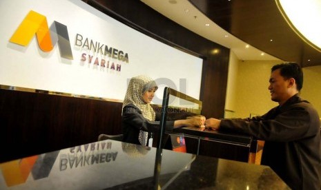 Teller menghitung nasabah uang di banking hall salah satu kantor Bank Mega Syariah, Jakarta, Kamis (3/7). (Republika/Prayogi).