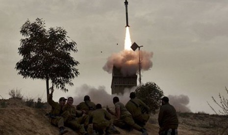 Tentara Israel sedang menyaksikan rudal yang diluncurkan dari sistem pertahanan rudal Iron Dome di selatan kota Beer Sheva. 