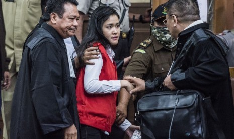 Terdakwa Jessica Kumala Wongso (tengah) berbincang dengan kuasa hukumnya seusai menjalani sidang perdana sebagai terdakwa kasus pembunuhan Wayan Mirna Salihin di Pengadilan Negeri Jakarta Pusat, Jakarta, Rabu (15/6).