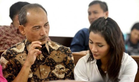 Terdakwa kasus pemberian FPJP dan penentuan Bank Century sebagai bank gagal berdampak sistemik, Budi Mulya (kiri) berbincang dengan putrinya Nadia Mulya (kanan) sebelum menjalani sidang dengan agenda pembacaan tuntutan di Pengadilan Tipikor, Jakarta, Senin