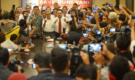 Terlapor kasus dugaan pengeditan video Ahok, Buni Yani (tengah) bersama pendukungnya mengepalkan tangan sebelum memberikan konferensi pers di Jakarta, Senin (7/11).