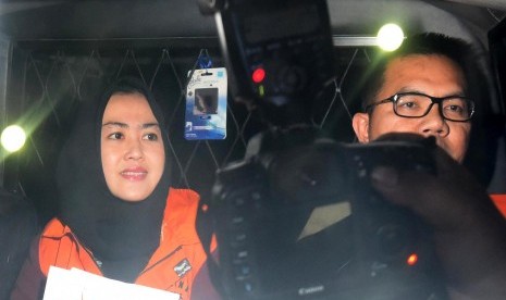 Tersangka korupsi Bupati Empat Lawang Budi Antoni Aljufri (kanan) dan istrinya Suzanna (tengah) meninggalkan Gedung KPK usai diperiksa di Jakarta, Senin (6/7).