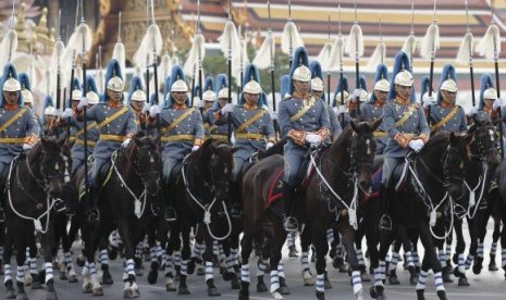 Thai Royal Guards ride their horses in front of the Grand Palace, during a military parade as a part of a celebration for the upcoming birthday of Thailand's King Bhumibol Adulyadej, in Bangkok, December 2, 2014. 