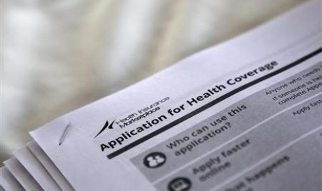 The federal government forms for applying for health coverage are seen at a rally held by supporters of the Affordable Care Act, widely referred to as 