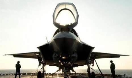 The flight deck crew secures an F-35B Lighting II aircraft aboard the amphibious assault ship USS Wasp following testing in this handout photo taken off the coast of North Carolina August 24, 2013.