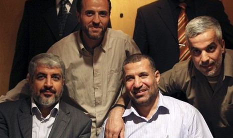 The late Palestinian commander of Hamas, Ahmed Al-Jabari sitsin the front row, second from left (file photo)  