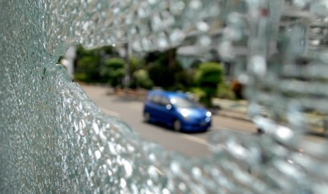 The picture shows broken glass at Trans Jakarta station in MT Haryono Street after an unidentified person shoots at the bus station on early Friday, August 9, 2013.